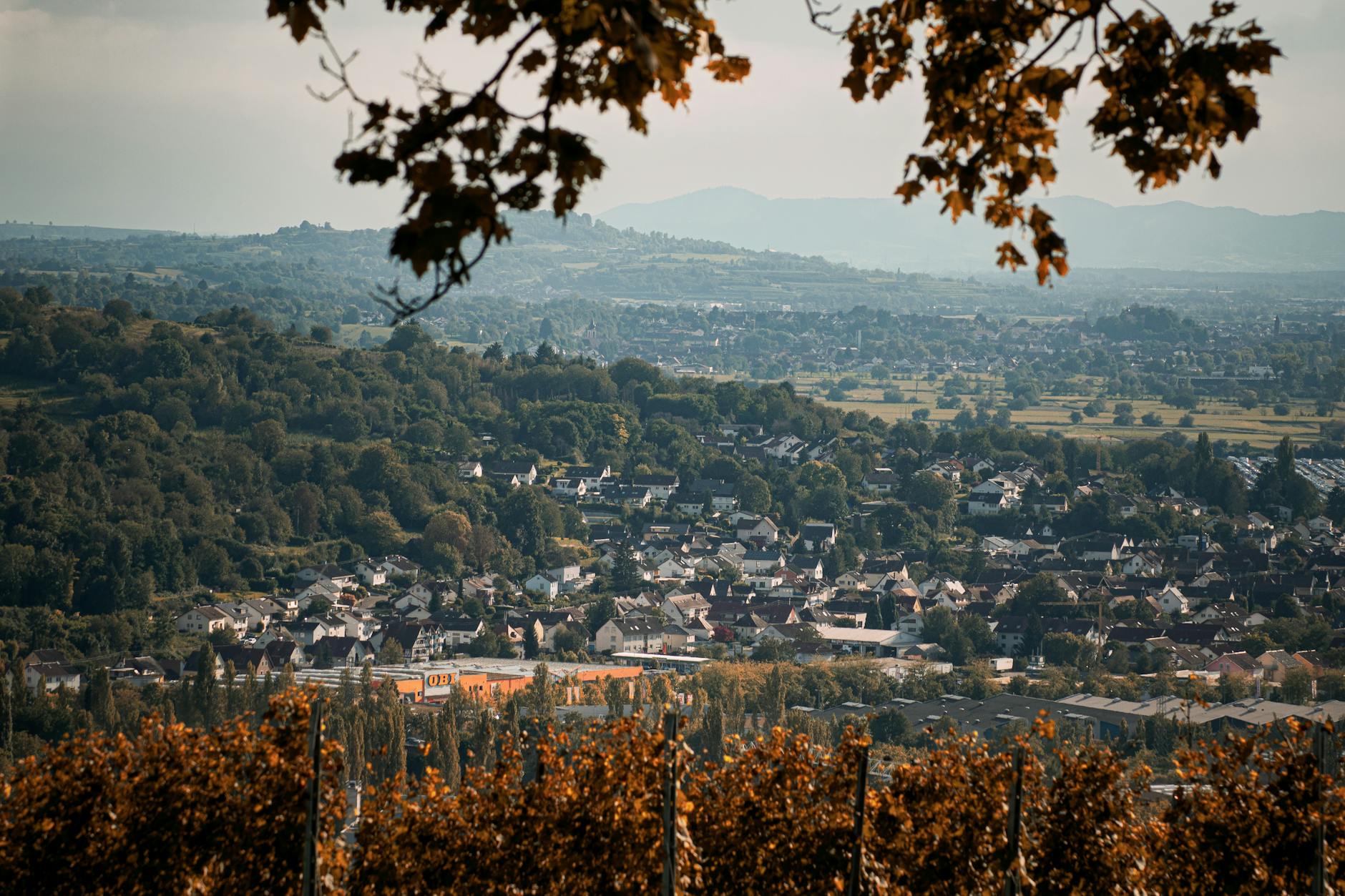 Picturesque autumn landscape overlooking a town in Baden-Württemberg surrounded by hills.